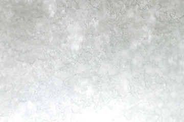 Frosted snow on a window, abstract background or texture 