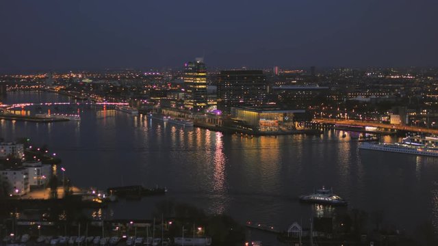 Amsterdam,01/09/2018: city skyline  ij river at night seen from above zoom out high angle view