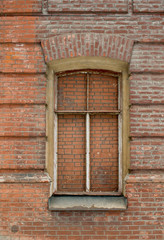 Wall of the old house and the briked up window
