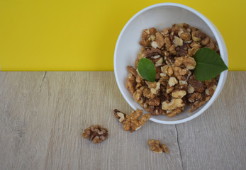 Composition of nuts on a yellow background.