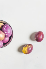 dyed easter eggs at white marble background