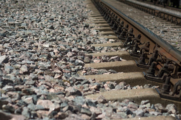 Railway Rails and concrete sleepers close-up on the rubble