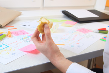 Office worker in ux development snacking apple in the workplace.