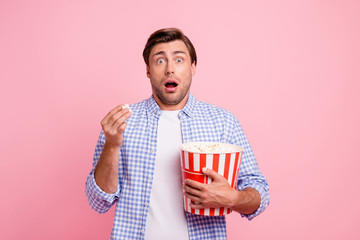 Naklejka premium Close up photo of beautiful amazing brunet he him his handsome hold pop corn oh no facial expression watching scary movie wearing specs casual checkered plaid shirt outfit isolated on rose background