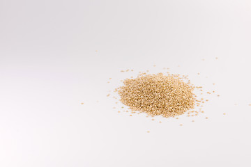 Pile of quinoa seeds isolated on a white background