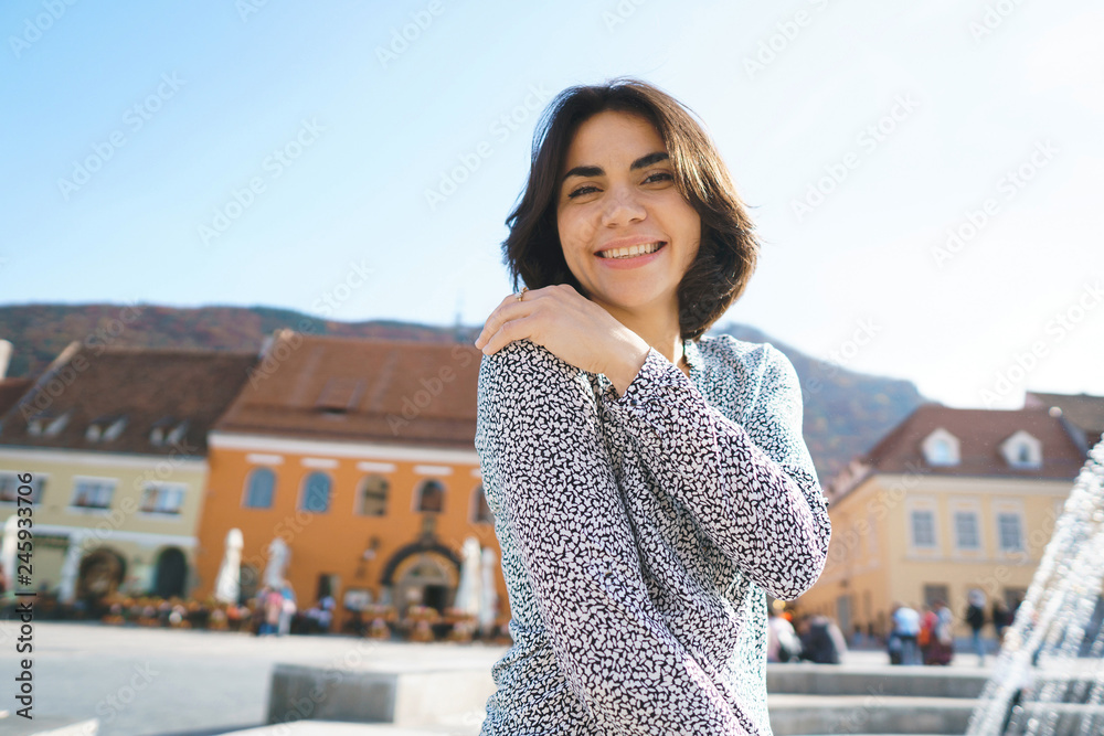 Sticker smiling woman in front of colorful houses