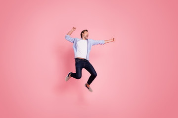 Fototapeta na wymiar Full length body size photo of jumping high crazy cheer he his him handsome glad about score strike bowling yelling loudly wearing casual jeans checkered plaid shirt isolated on rose background