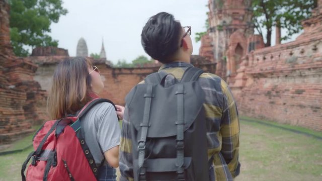 Traveler Asian couple spending holiday trip at Ayutthaya, Thailand, backpacker sweet couple enjoy their journey at amazing landmark in traditional city. Lifestyle couple travel holidays concept.