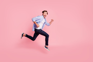 Fototapeta na wymiar Full length side profile body size photo of jumping high he his him handsome run fast look oh yeah yes expression rushing wearing casual jeans checkered plaid shirt isolated on rose background