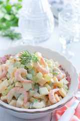 Salad with shrimps and fresh cucumber on a white background, selective focus