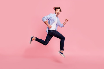 Fototapeta na wymiar Full length side profile body size photo of jumping high he his him handsome run fast look oh yeah yes expression hair fly flow wearing casual jeans checkered plaid shirt isolated on rose background