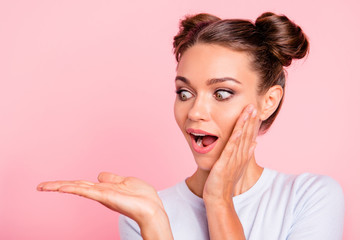 Close-up portrait of her she nice attractive winsome cheerful shocked girl lady holding looking at object on palm isolated over pastel pink background - obrazy, fototapety, plakaty