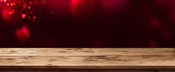 Dark background with red hearts and wooden table