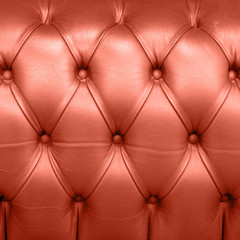 Living Coral color of the Year 2019. Leather Upholstery Background with coral in trendy color