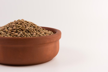 Yellow lentil in a bowl isolated on white background