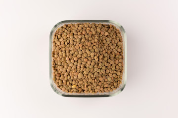 Yellow lentil in a bowl isolated on white background