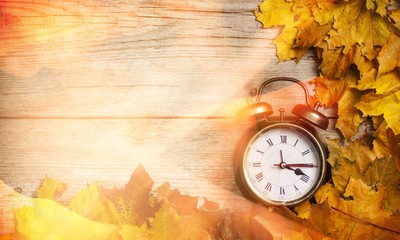 Vintage alarm clock on wooden background