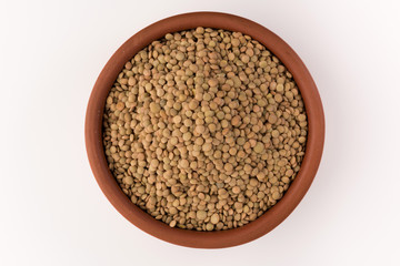 Yellow lentil in a bowl isolated on white background