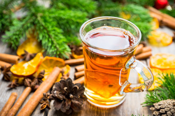 Hot tea in glass cup with atmospheric winter decorations. Selective focus. Shallow depth of field.