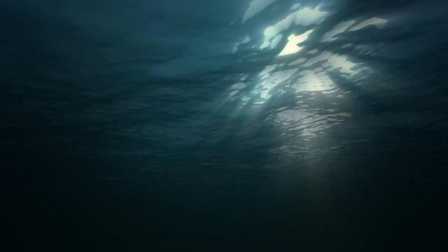 Under water ocean waves and sun light. Seamless loop 