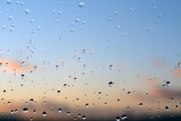 Rain drops on window with blured background.