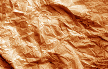 Crumpled sheet of paper in orange color.