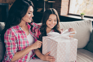 Close up photo two people cuddle mum little daughter satisfied adorable sit with big giftbox 8-march party present mommy wear pink plaid shirts flat apartment room comfortable cozy couch sofa divan