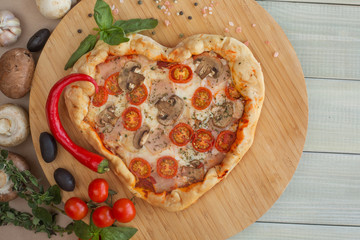 Pizza heart shaped on wood