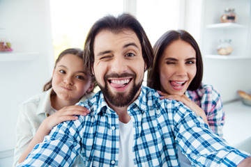 Self-portrait of nice cute sweet lovely attractive trendy cheerful cheery childish positive people mom dad rejoicing spending time having fun in light white modern interior indoors