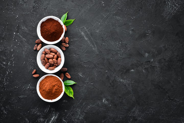 Cocoa beans, cocoa powder is dark and light. On a black background. Top view.