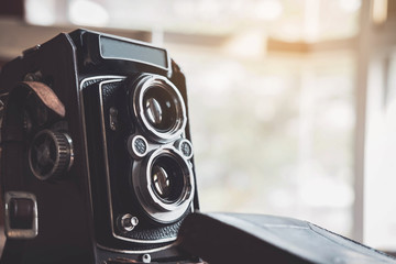 Old retro camera on old wooden background