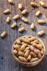 Peanut, snack, in wood bowl on classic wooden table background