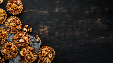 Cookies with caramelized nuts. On a wooden background. Top view. Free copy space.