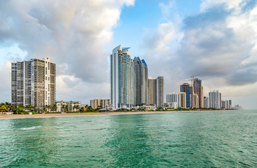 Obraz premium empty beach at Sunny isles beach, Miami in early morning with skyscraper
