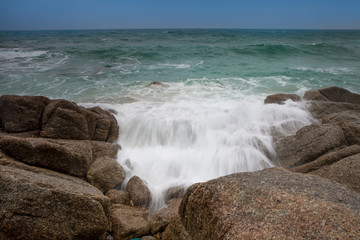 Fototapeta na wymiar Blue Ocean Crashing on Rocks