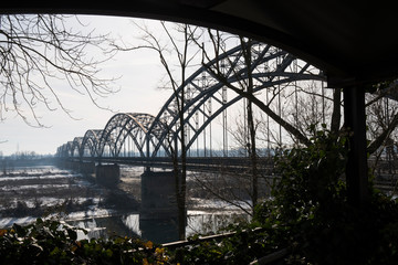 Gerola bridge in winter. Ancient iron bridge, built in 1913, on the river Po in the province of Pavia (Italy).