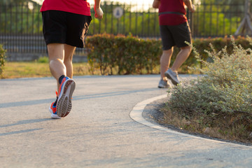 Sport background, Man runner's legs run on the street of public with copy space.