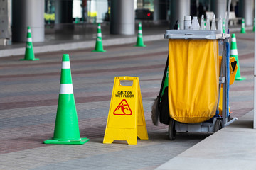 Janitorial and mop bucket on cleaning in process.