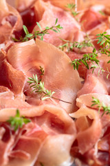 Italian prosciutto crudo or jamon with thyme .