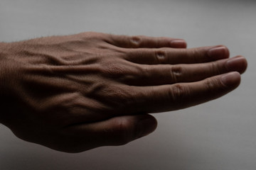 The hand lies on the table (windowsill). palm is a paper symbol