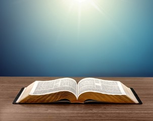 Open book on old wooden table