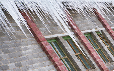 big icicles hanging on a roof