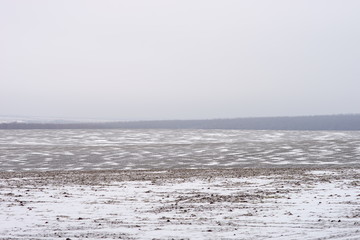 Land field covered in frost in the onset of early winter