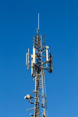 Telecoms tower on a brigt blue sky