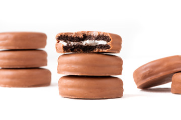 Chocolate biscuit sandwich in chocolate glaze on white background.