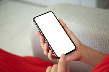 female hands in red dress holding phone with an isolated screen