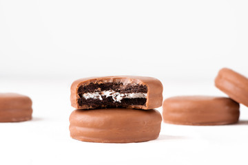 Chocolate biscuit sandwich in chocolate glaze on white background.