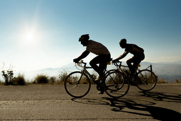  bike race in uphill road bikers shandows sun