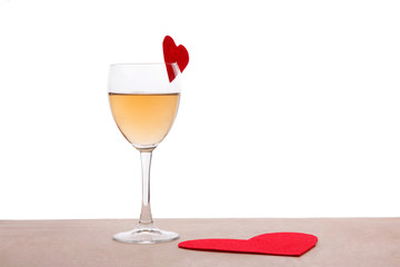 Glass and red paper forms of heart for Valentine's Day on the wood table