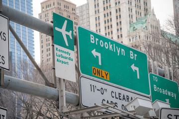 Brooklyn Bridge and Airports street signs in New York City